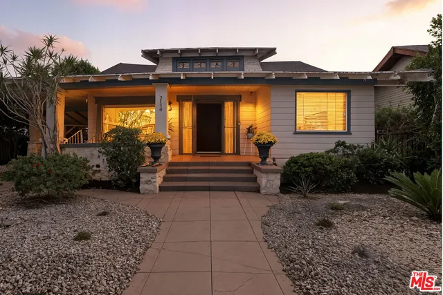 a view of a house with potted plants