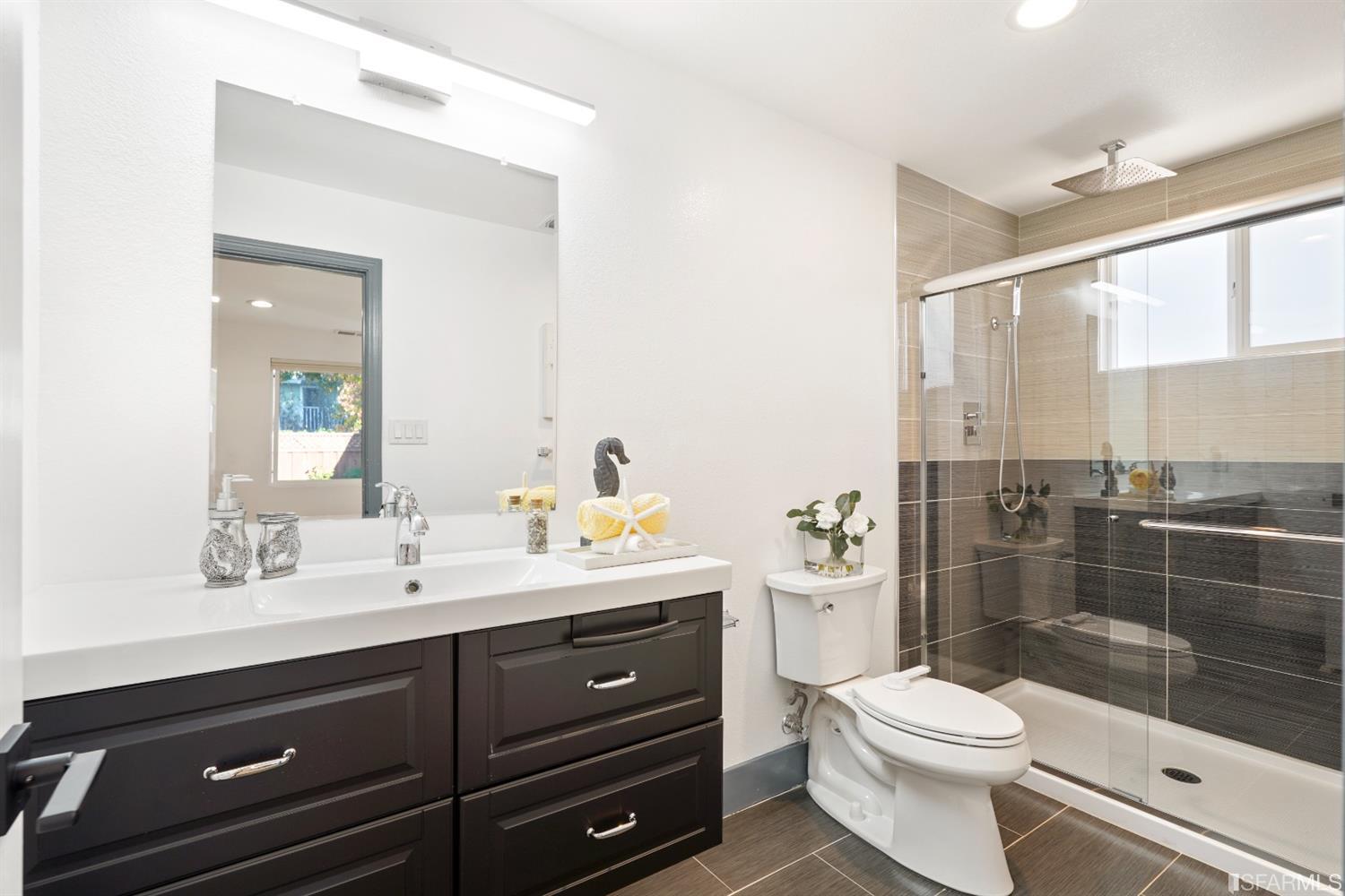 3143 Cadman Road Fremont, CA 94538 - Photo 20 of 54 a bathroom with a toilet a sink a mirror a window and vanity