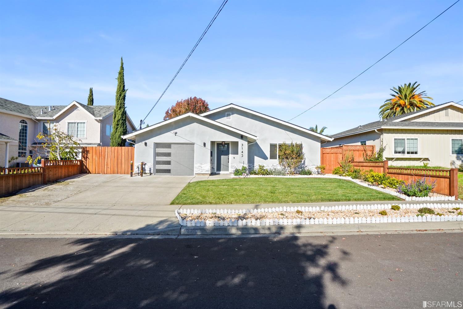 3143 Cadman Road Fremont, CA 94538 - Photo 35 of 54 a front view of a house with a garden and pathway