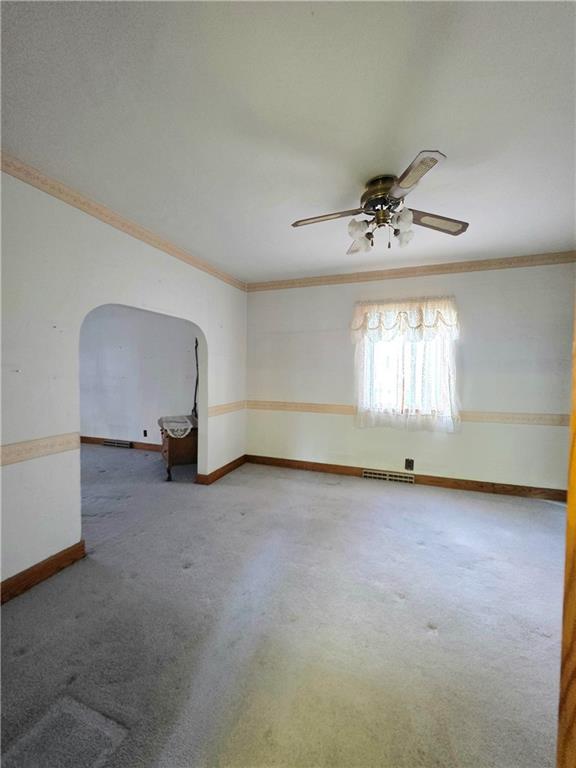 63 West Main Street, Unit 73 Yatesboro, PA 16263 - Photo 14 of 38 an empty room with windows and chandelier fan