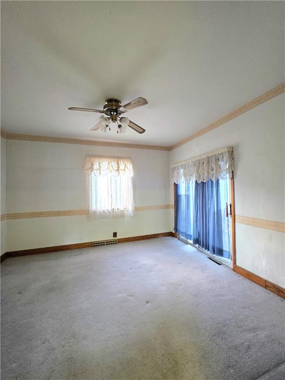 63 West Main Street, Unit 73 Yatesboro, PA 16263 - Photo 15 of 38 an empty room with a window and a ceiling fan