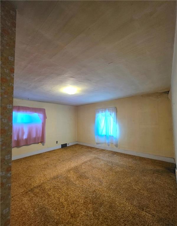 63 West Main Street, Unit 73 Yatesboro, PA 16263 - Photo 18 of 38 an empty room with windows and fireplace