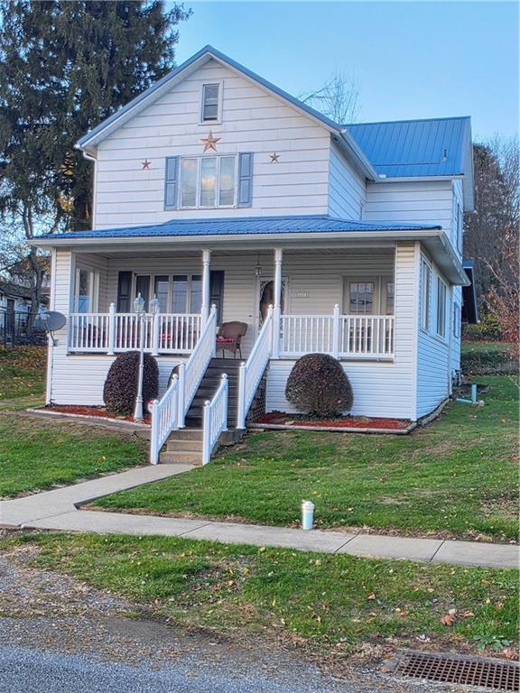 63 West Main Street, Unit 73 Yatesboro, PA 16263 - Photo 3 of 38 a front view of a house with a yard and porch
