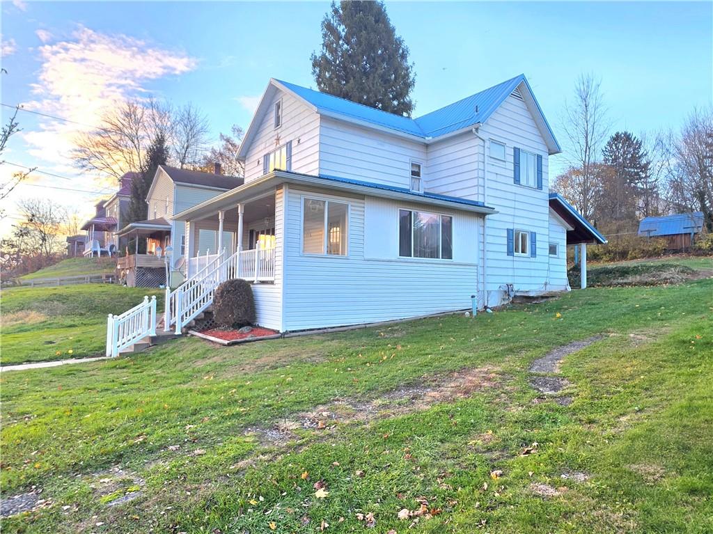 63 West Main Street, Unit 73 Yatesboro, PA 16263 - Photo 4 of 38 a view of a house with a yard and sitting area