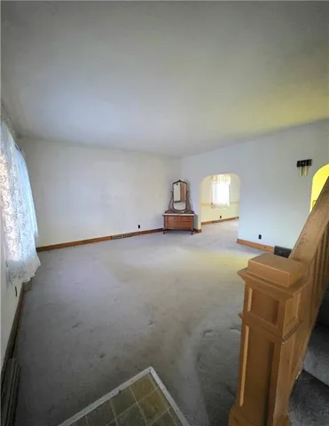 a view of an empty room and wooden floor