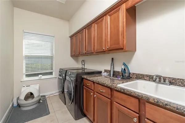 a kitchen with a sink cabinets and window
