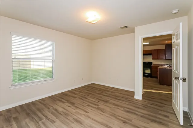 wooden floor in an empty room with a window