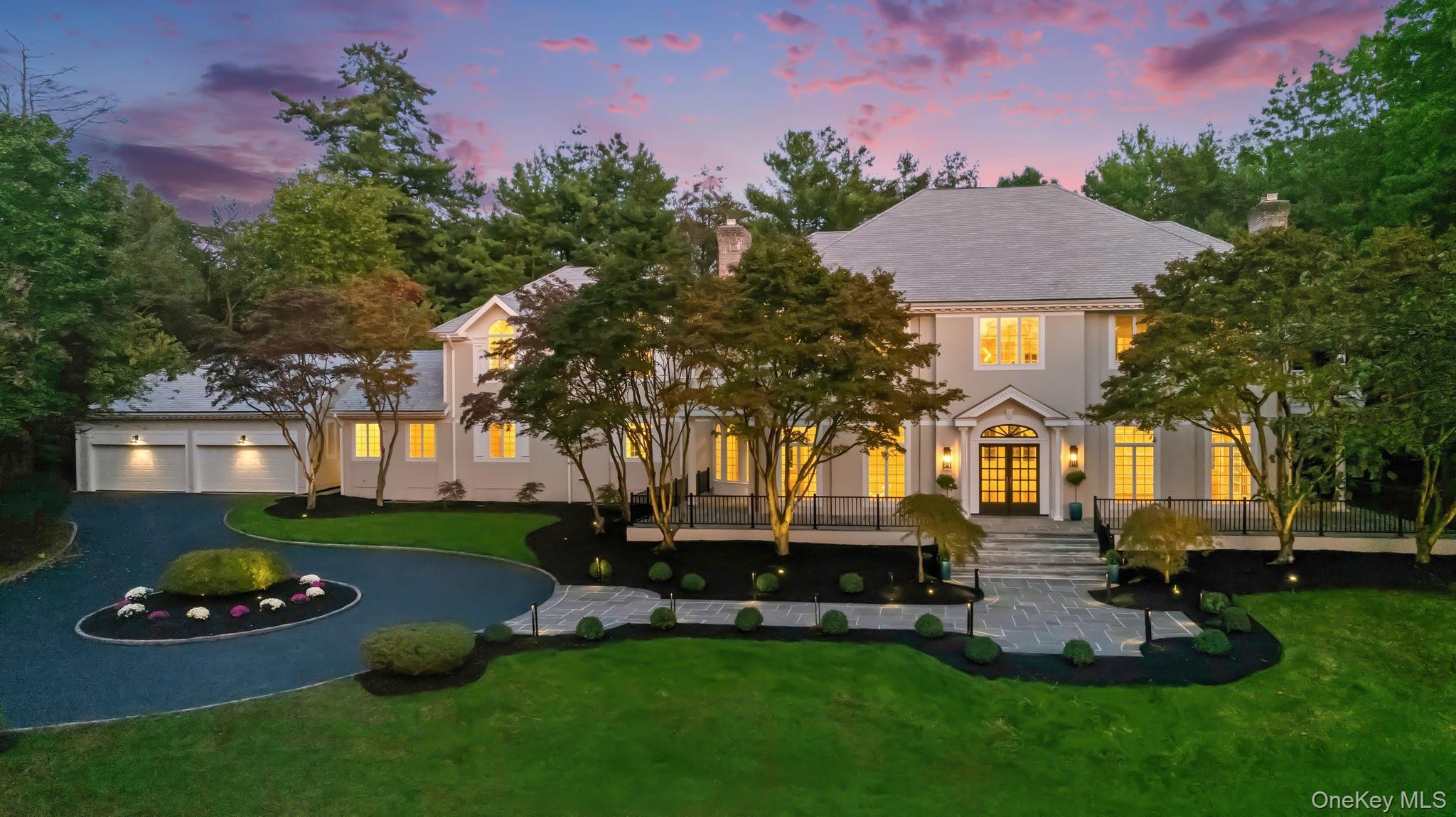 10 Cooper Road Scarsdale, NY 10583 - Photo 2 of 47 a front view of a house with a garden and yard