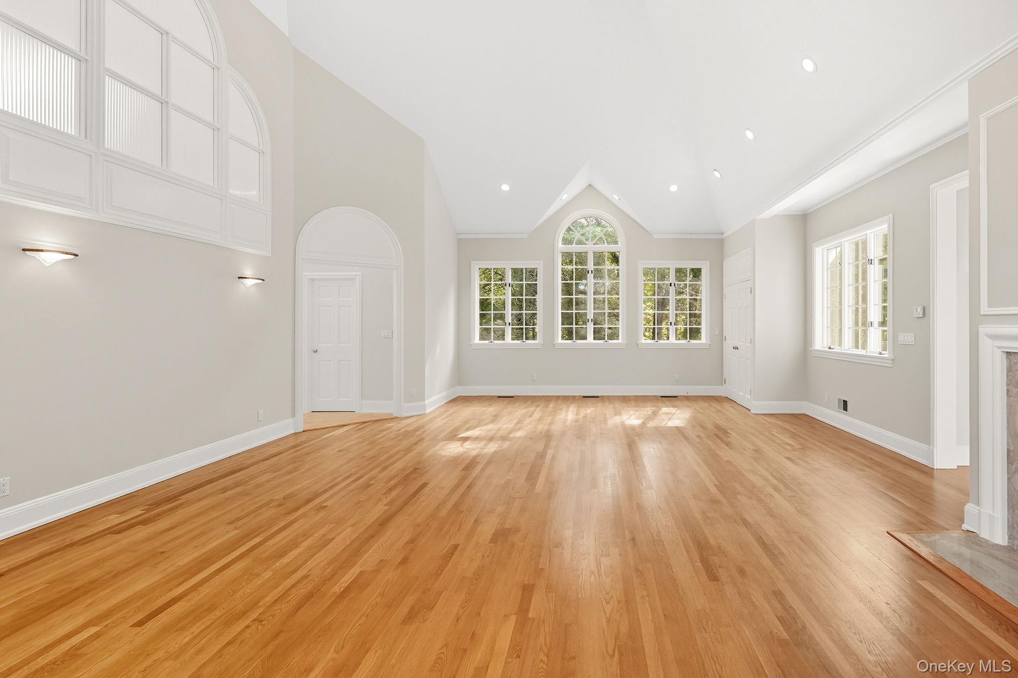 10 Cooper Road Scarsdale, NY 10583 - Photo 27 of 47 an empty room with wooden floor and windows
