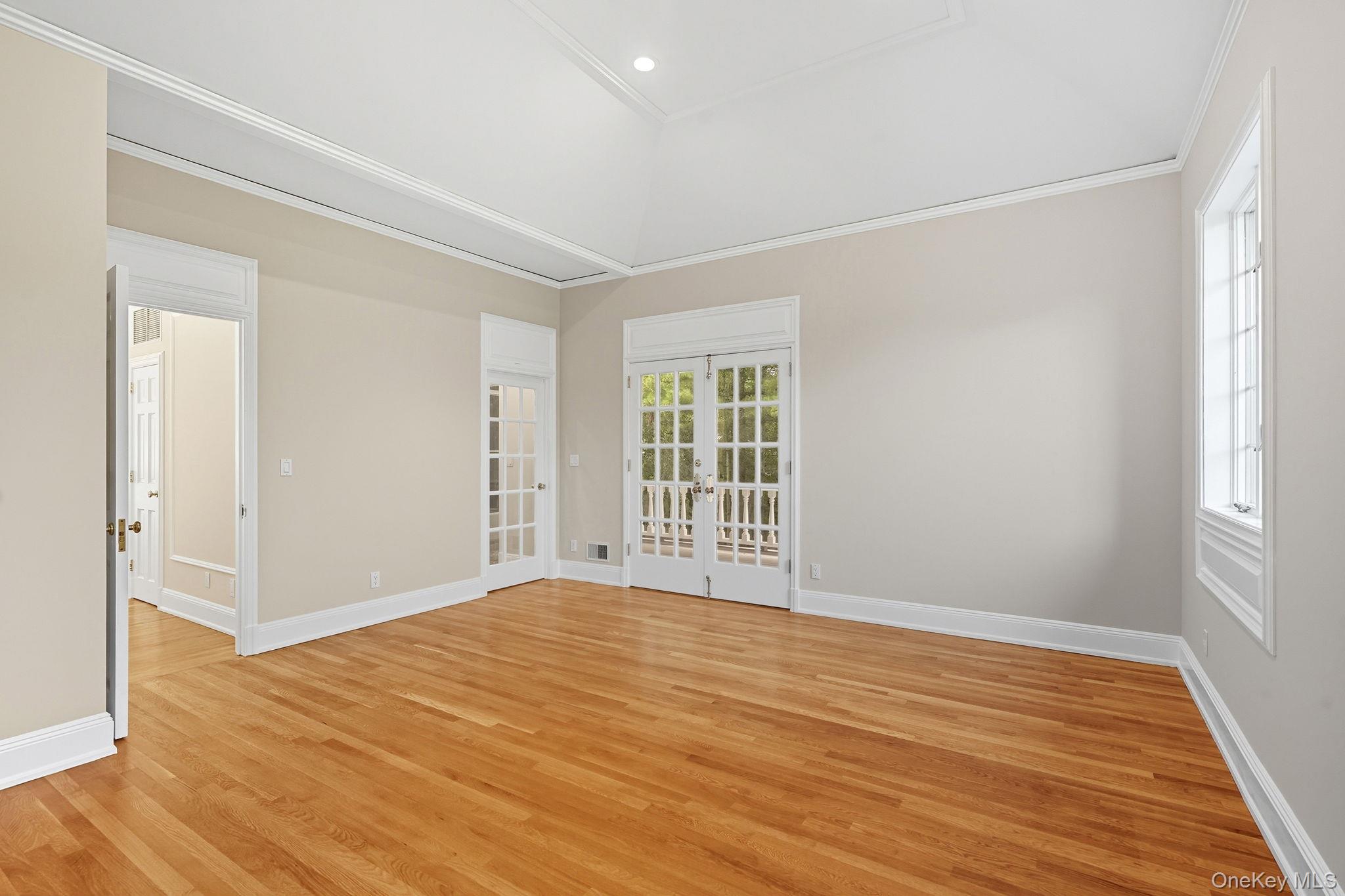 10 Cooper Road Scarsdale, NY 10583 - Photo 33 of 47 a view of an empty room with wooden floor and a window