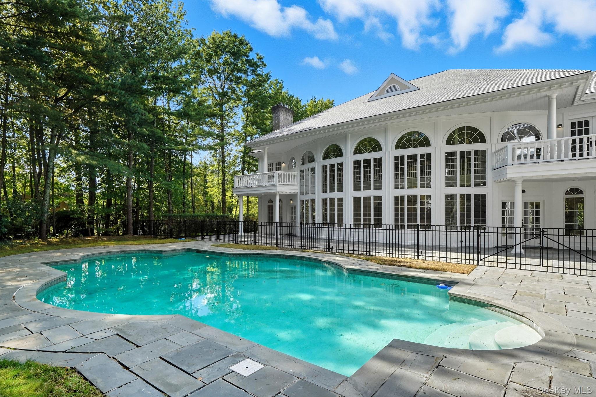 10 Cooper Road Scarsdale, NY 10583 - Photo 40 of 47 a view of a house with a yard and a patio