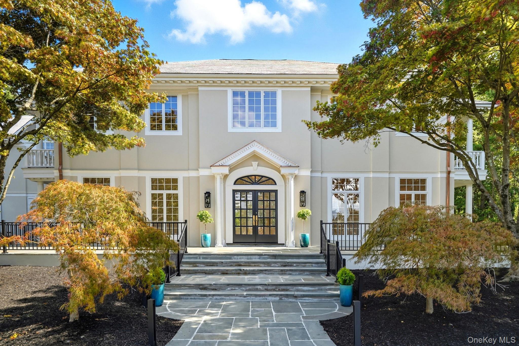 10 Cooper Road Scarsdale, NY 10583 - Photo 4 of 47 a front view of a house with a garden