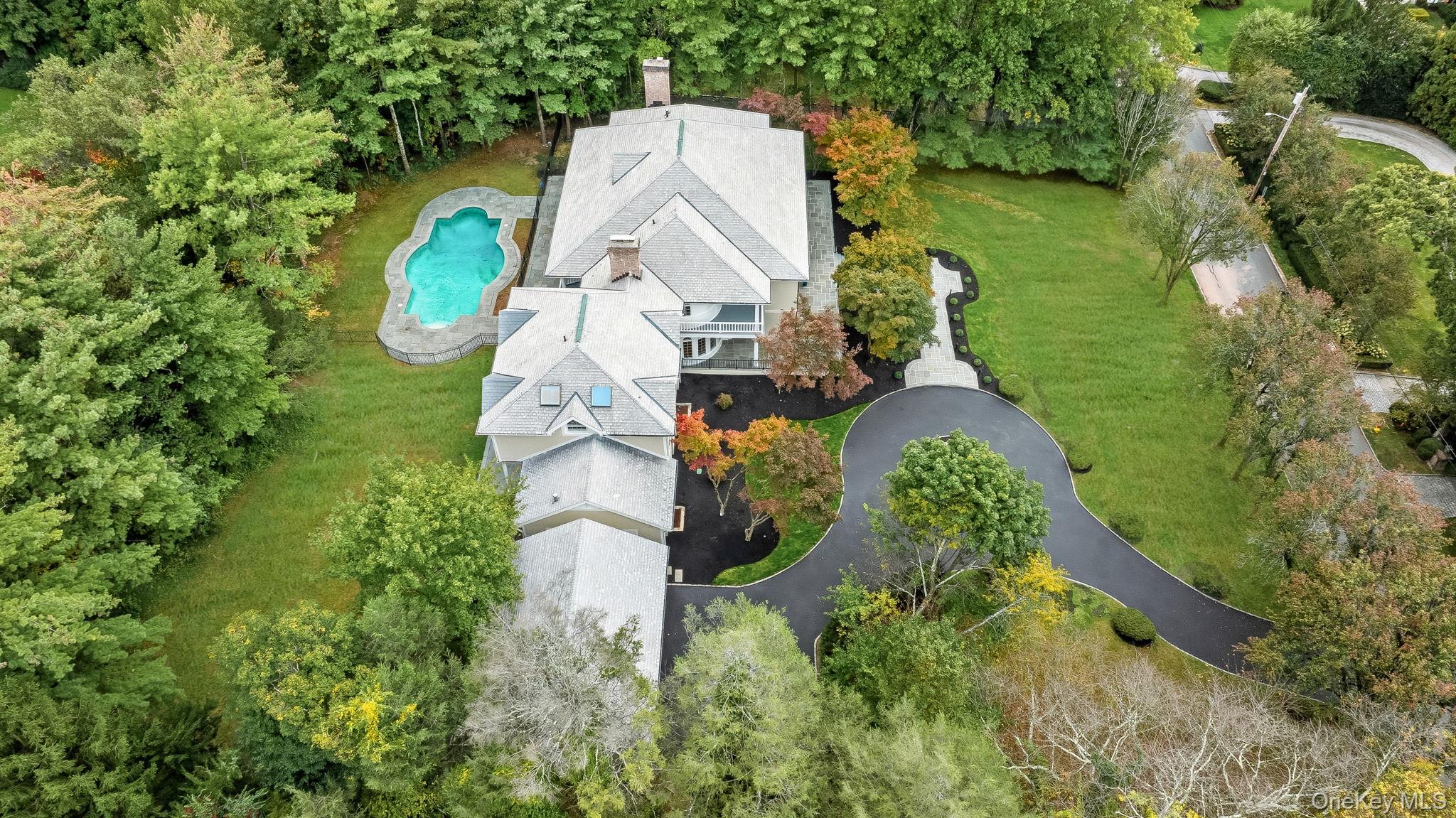 10 Cooper Road Scarsdale, NY 10583 - Photo 43 of 47 an aerial view of a house with outdoor space and a lake view