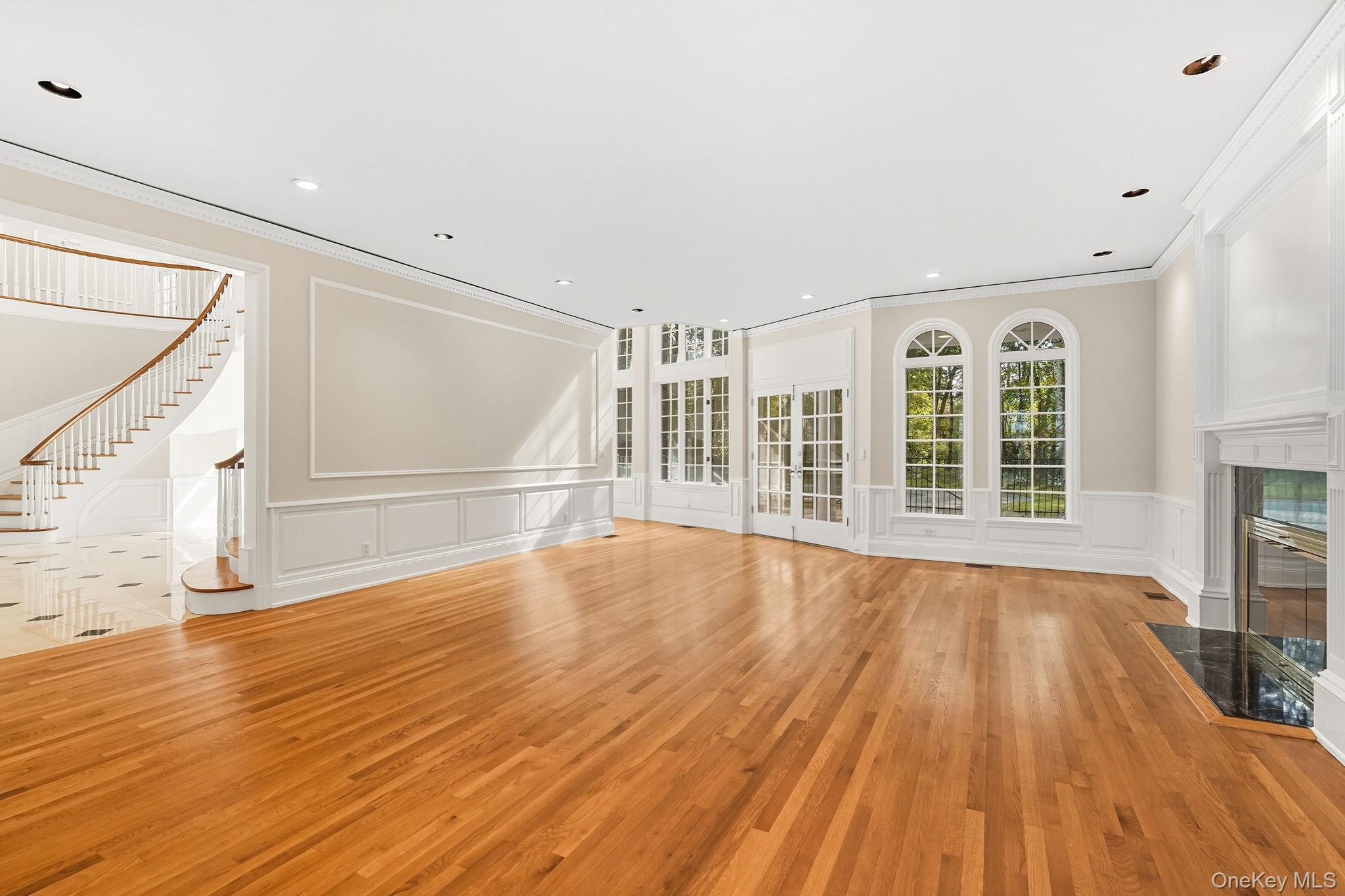 10 Cooper Road Scarsdale, NY 10583 - Photo 10 of 47 a view of an empty room with wooden floor and a window