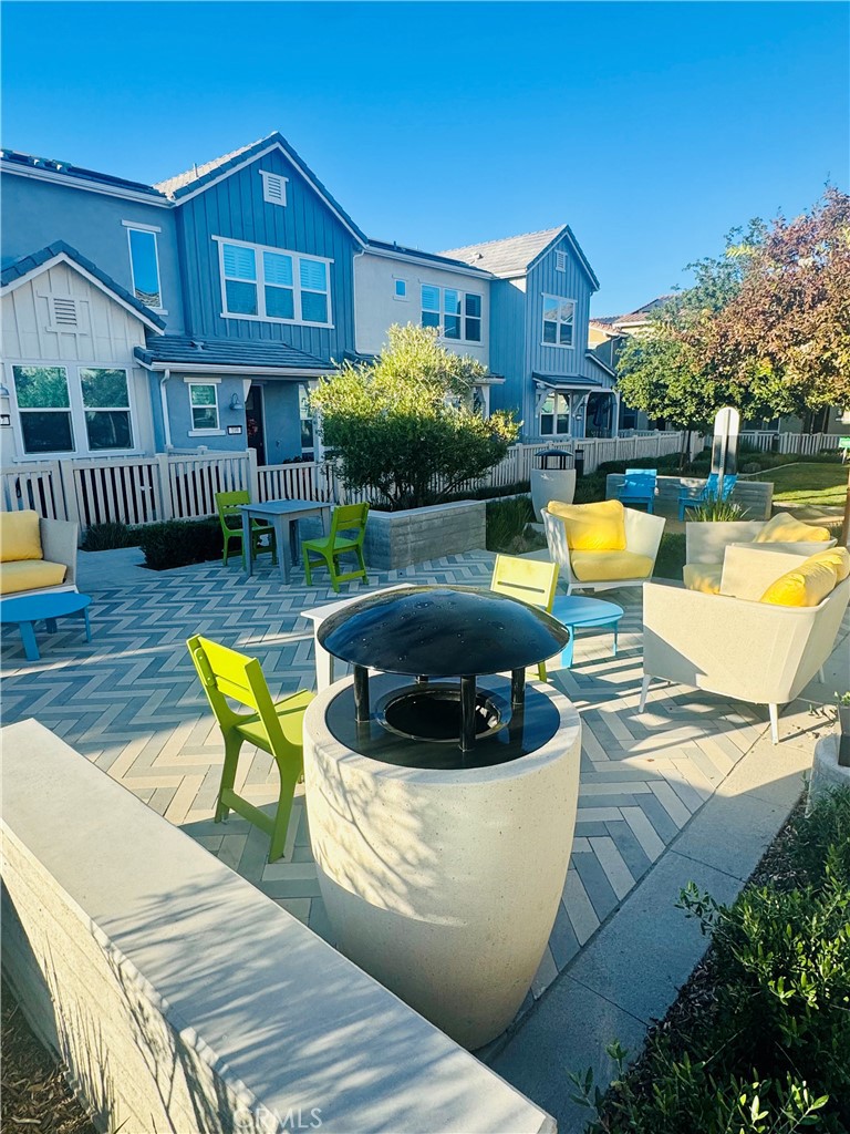 a view of a house with pool and chairs