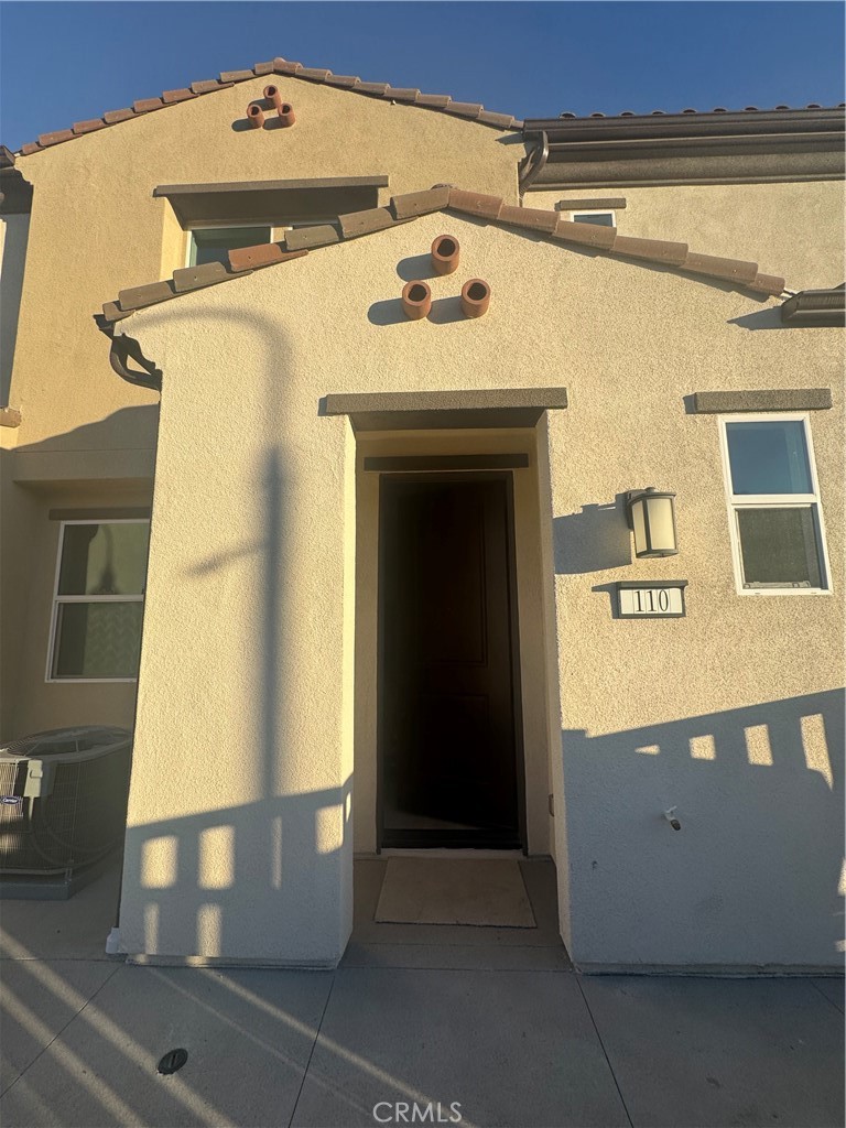 3972 Lavine Way, Unit 110 Corona, CA 92883 - Photo 2 of 9 a front view of a building with garage