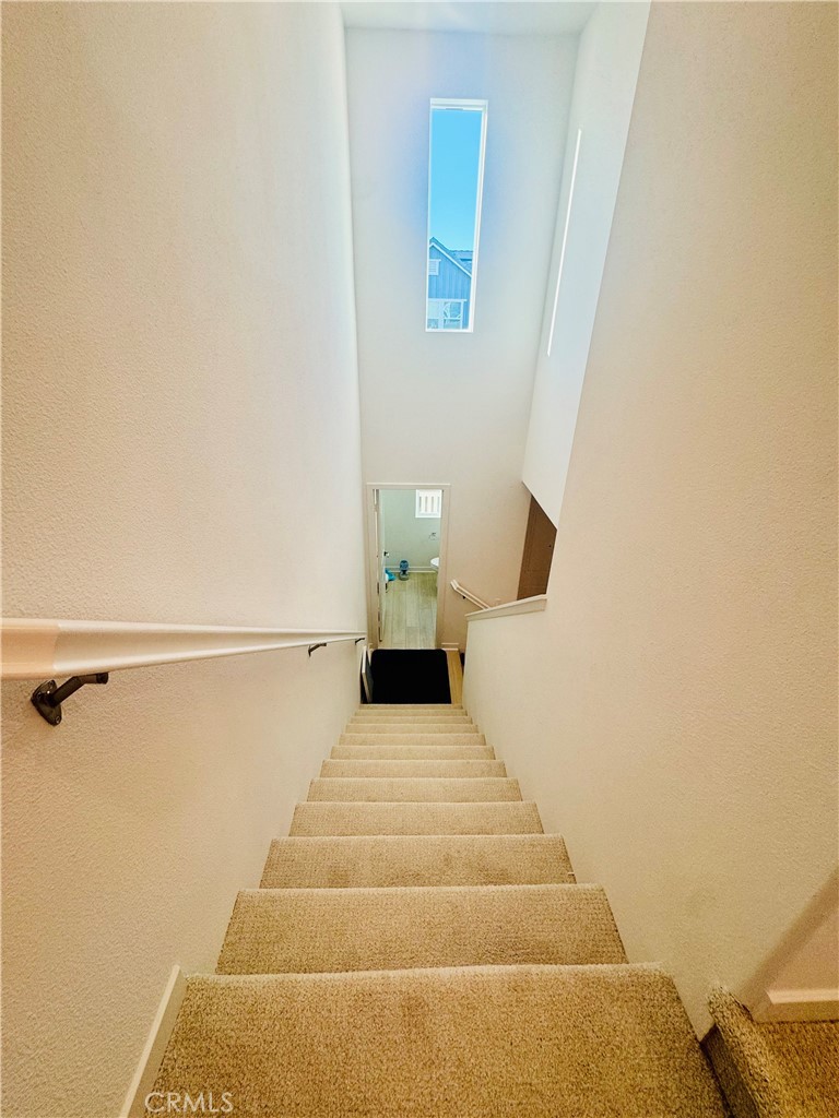 3972 Lavine Way, Unit 110 Corona, CA 92883 - Photo 5 of 9 a view of a bedroom with wooden floor and chair