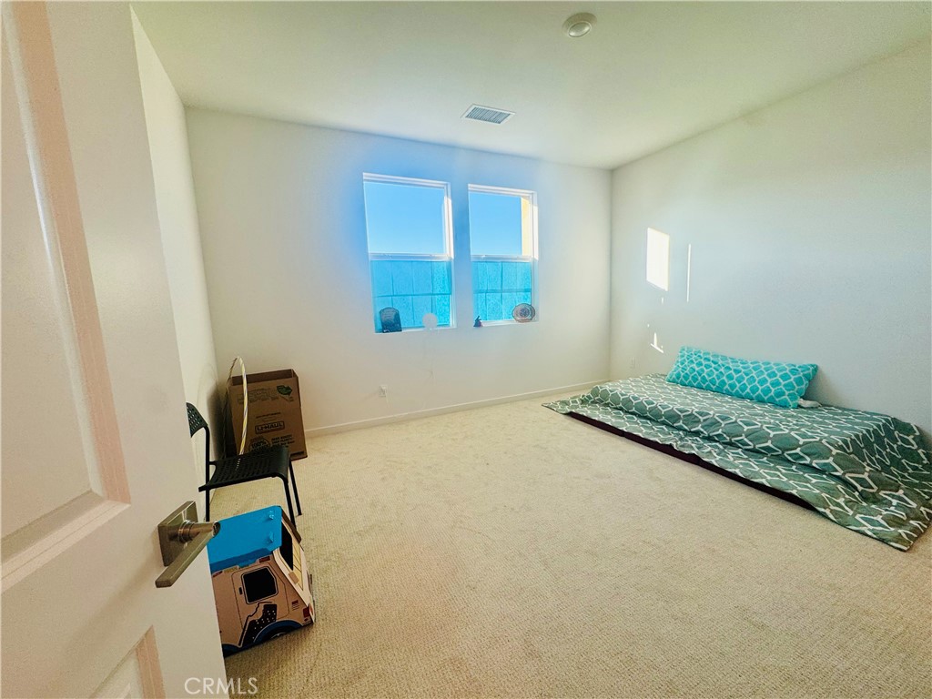 3972 Lavine Way, Unit 110 Corona, CA 92883 - Photo 8 of 9 a bedroom with a bed and a window