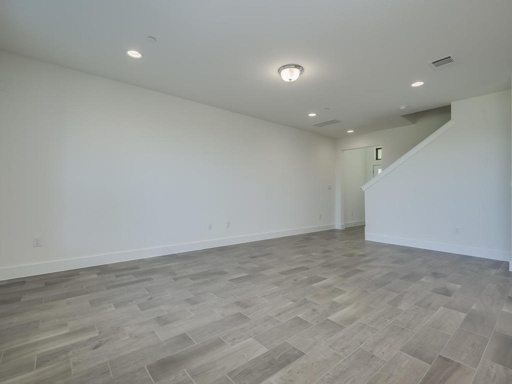 12327 Maypole Bend Austin, TX 78717 - Photo 7 of 30 an empty room with wooden floor and fan