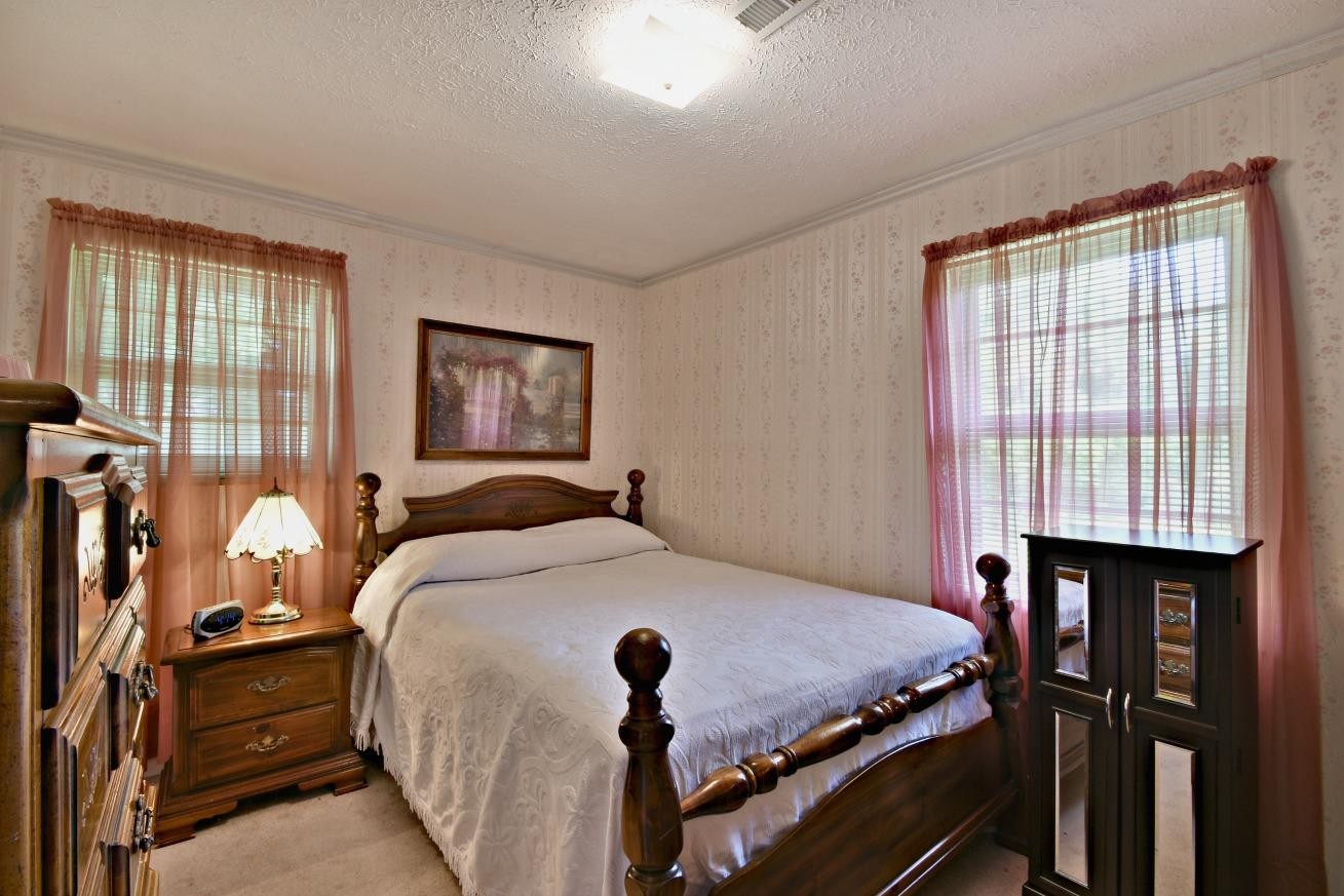 6100 McNeely Road Corryton, TN 37721 - Photo 11 of 17 a bed sitting in a bedroom next to a window