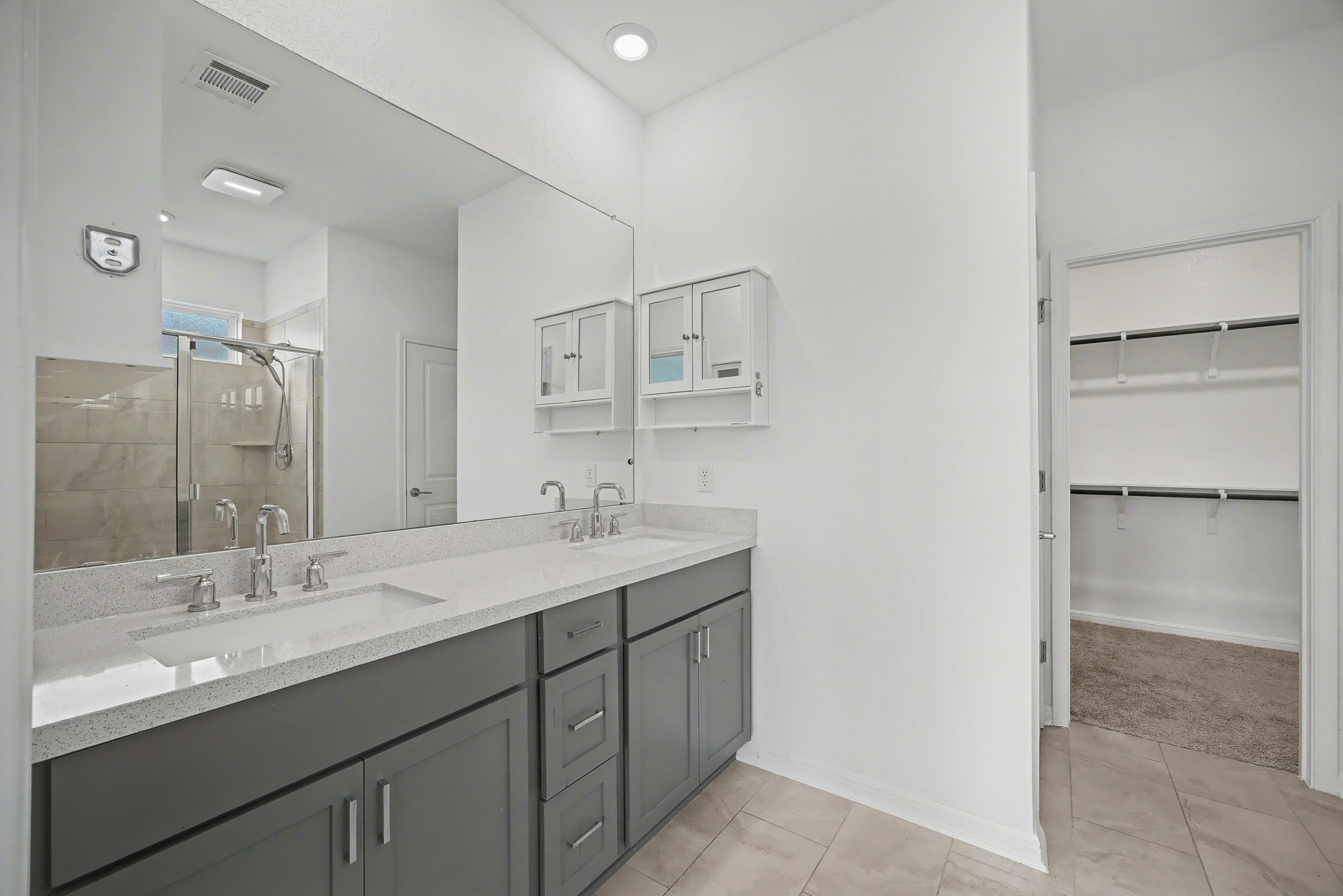 424 Spindrift Lane Leander, TX 78641 - Photo 15 of 26 a bathroom with a double vanity sink and mirror