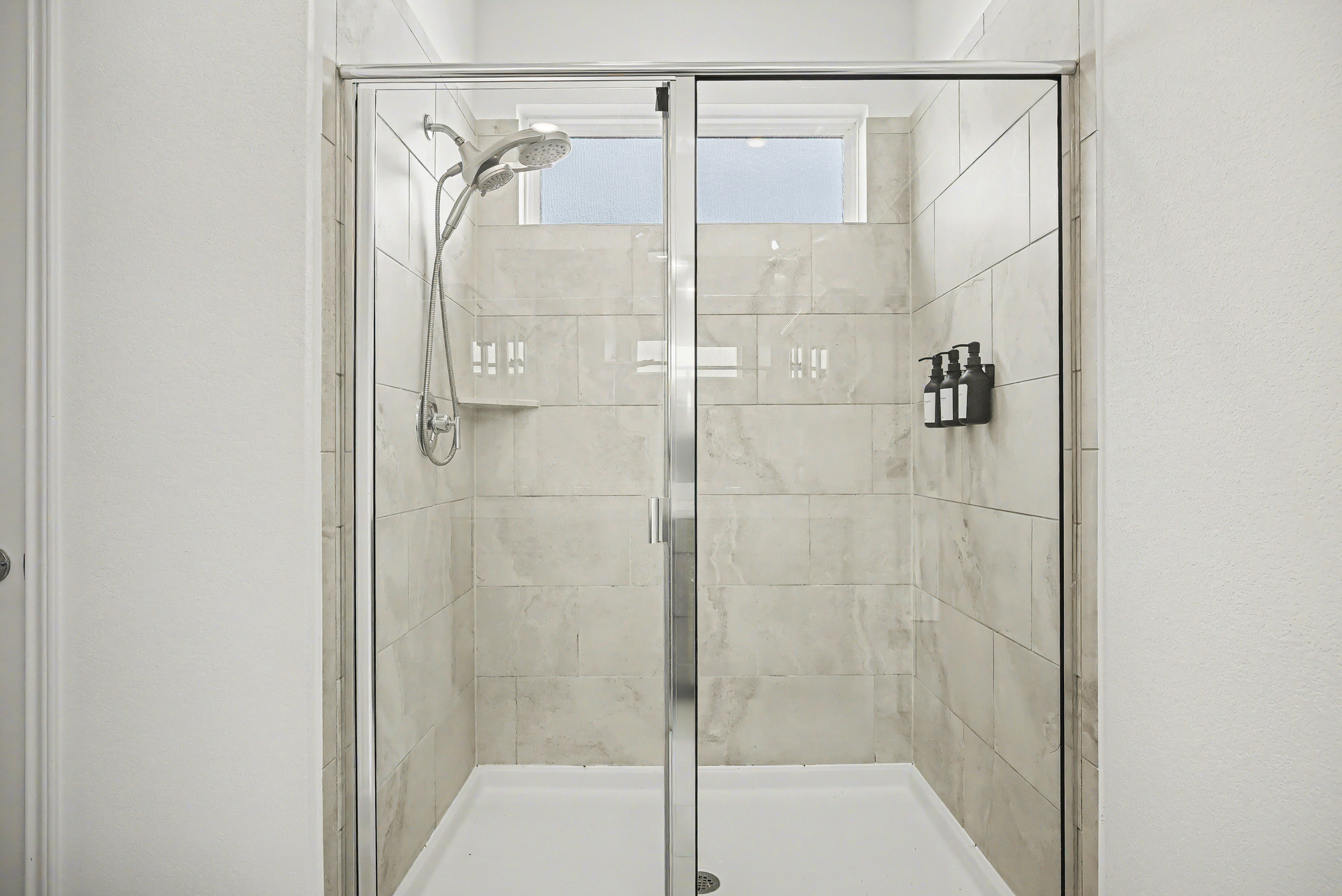 424 Spindrift Lane Leander, TX 78641 - Photo 16 of 26 a bathroom with a glass shower door