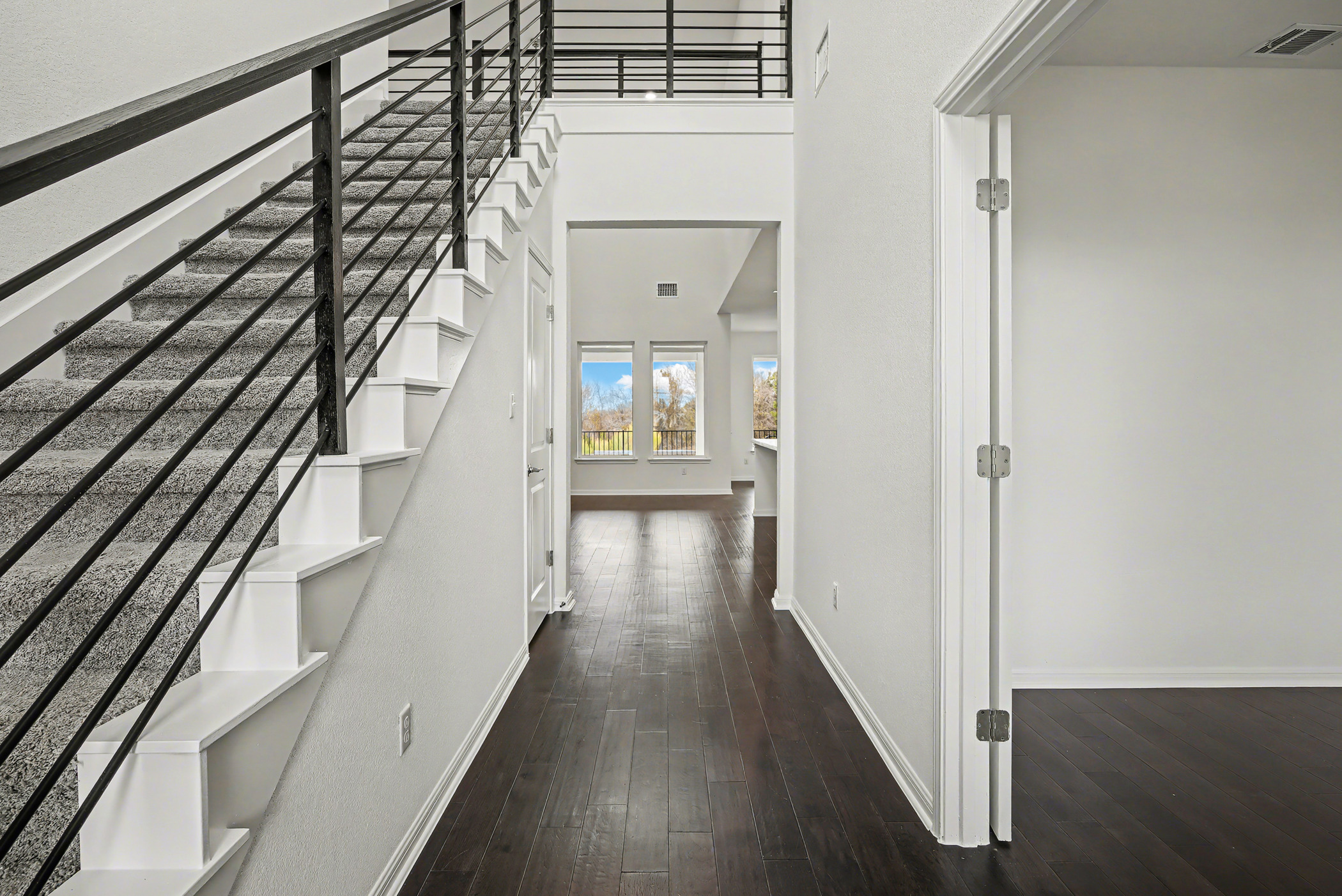 424 Spindrift Lane Leander, TX 78641 - Photo 2 of 26 a view of a hallway with wooden floor and staircase