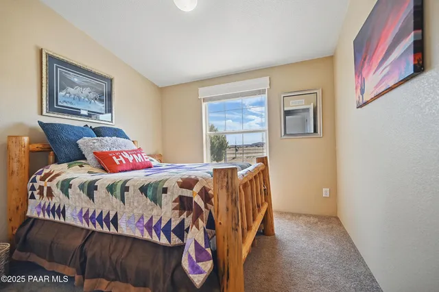 a bedroom with bed and a window