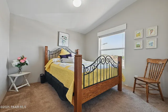 a bedroom with a bed and a chair