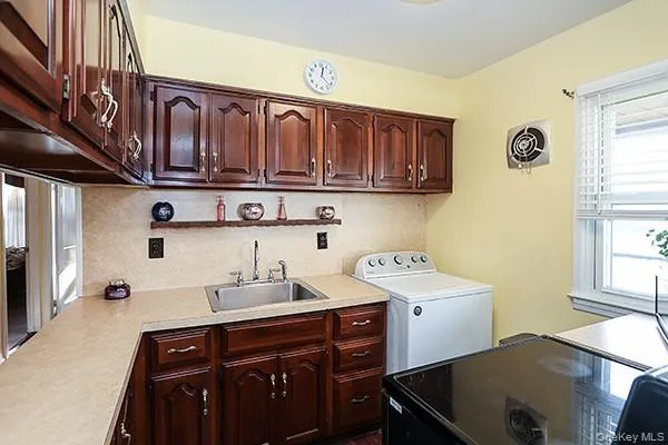 a kitchen with a sink cabinets and a window