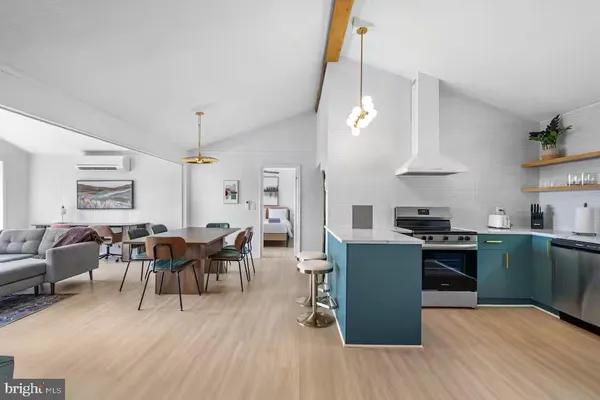 a kitchen with stainless steel appliances granite countertop wooden floors and stove