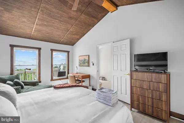a bedroom with furniture and a flat screen tv