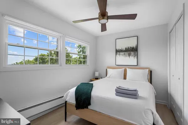 a bedroom with a bed and a large window