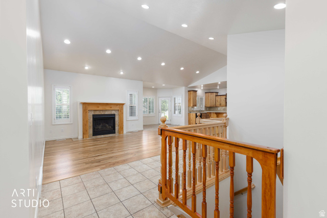 2327 Bluff Ridge Drive Syracuse, UT 84075 - Photo 11 of 66 Spacious living area featuring wood-finish flooring, recessed lighting, and a fireplace with a stone surround and wood mantel