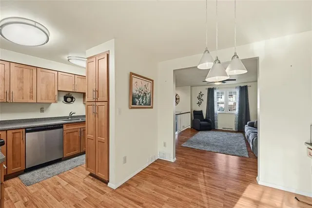 a kitchen with stainless steel appliances granite countertop a sink and cabinets