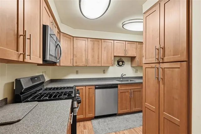 a kitchen with a sink a stove and cabinets