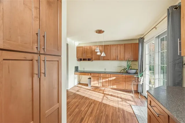 a spacious bathroom with a granite countertop sink and a large mirror