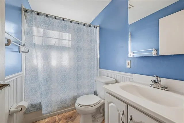 a bathroom with a sink toilet and shower