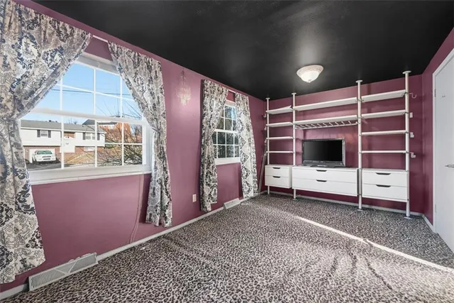 a view of an empty room with a fireplace