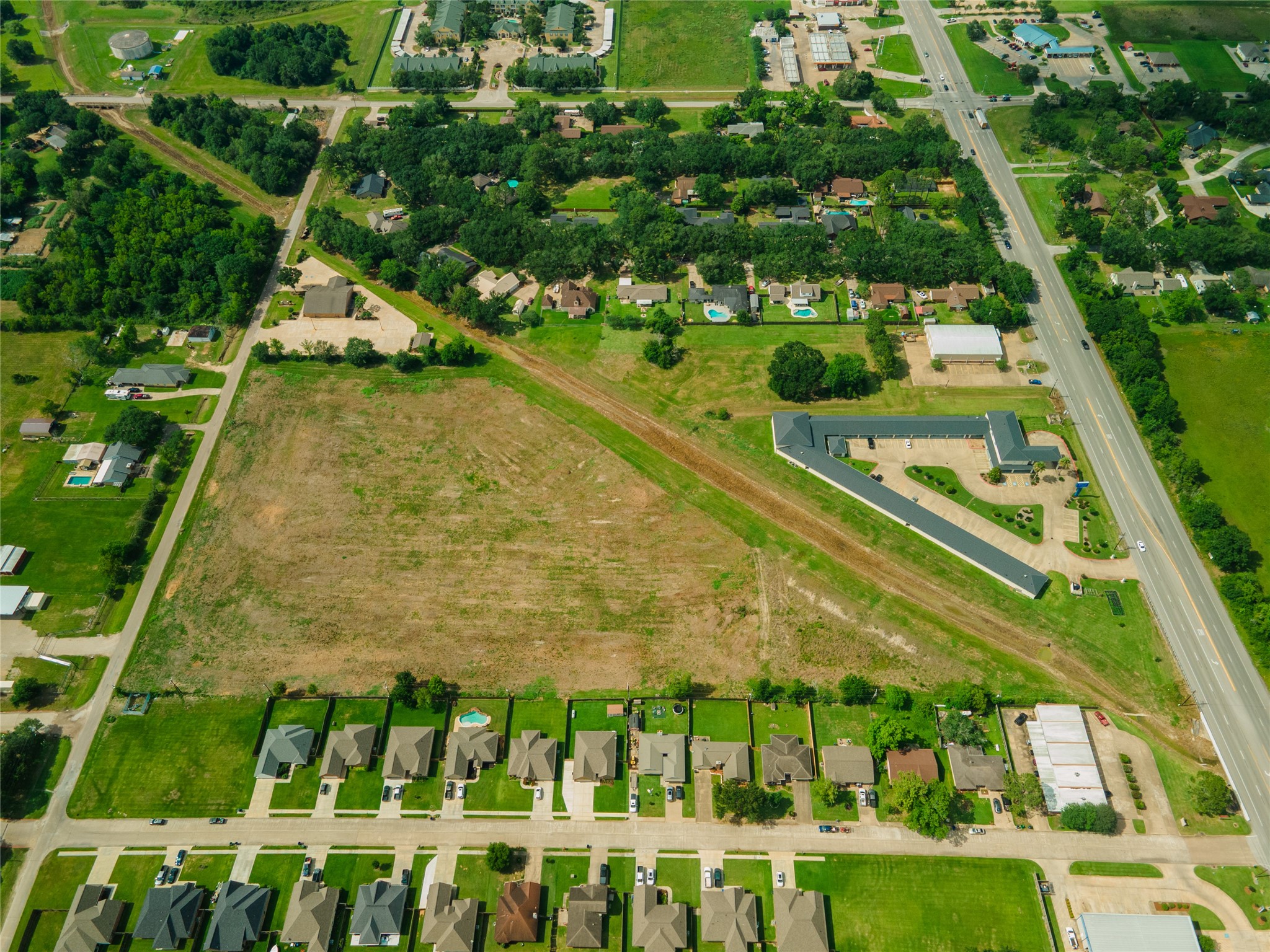0 Karankawa Street Angleton, TX 77515 - Photo 20 of 22 a view of a swimming pool with a yard