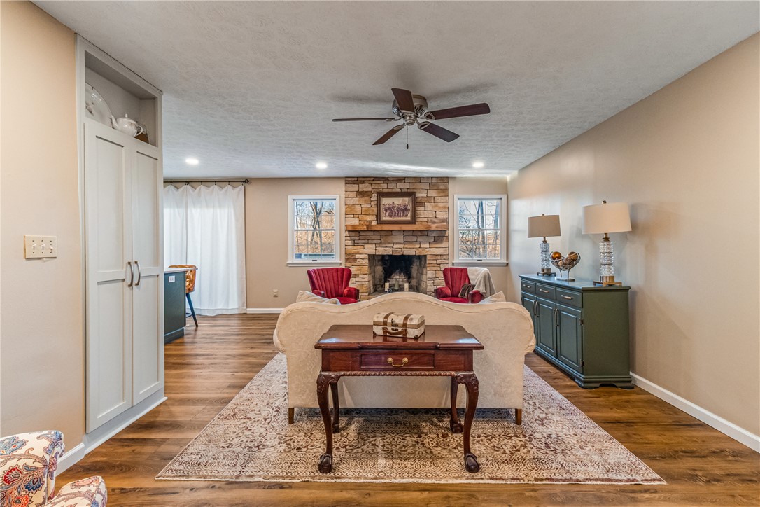 610 West Alex Bell Road Dayton, OH 45459 - Photo 12 of 36 This inviting living area features warm wood flooring and a stone fireplace.