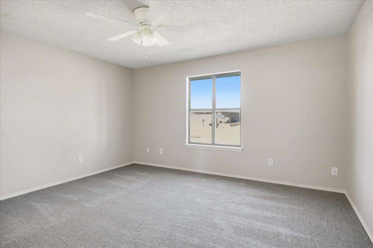 2301 92nd Street Lubbock, TX 79423 - Photo 14 of 30 an empty room with a window and a fan