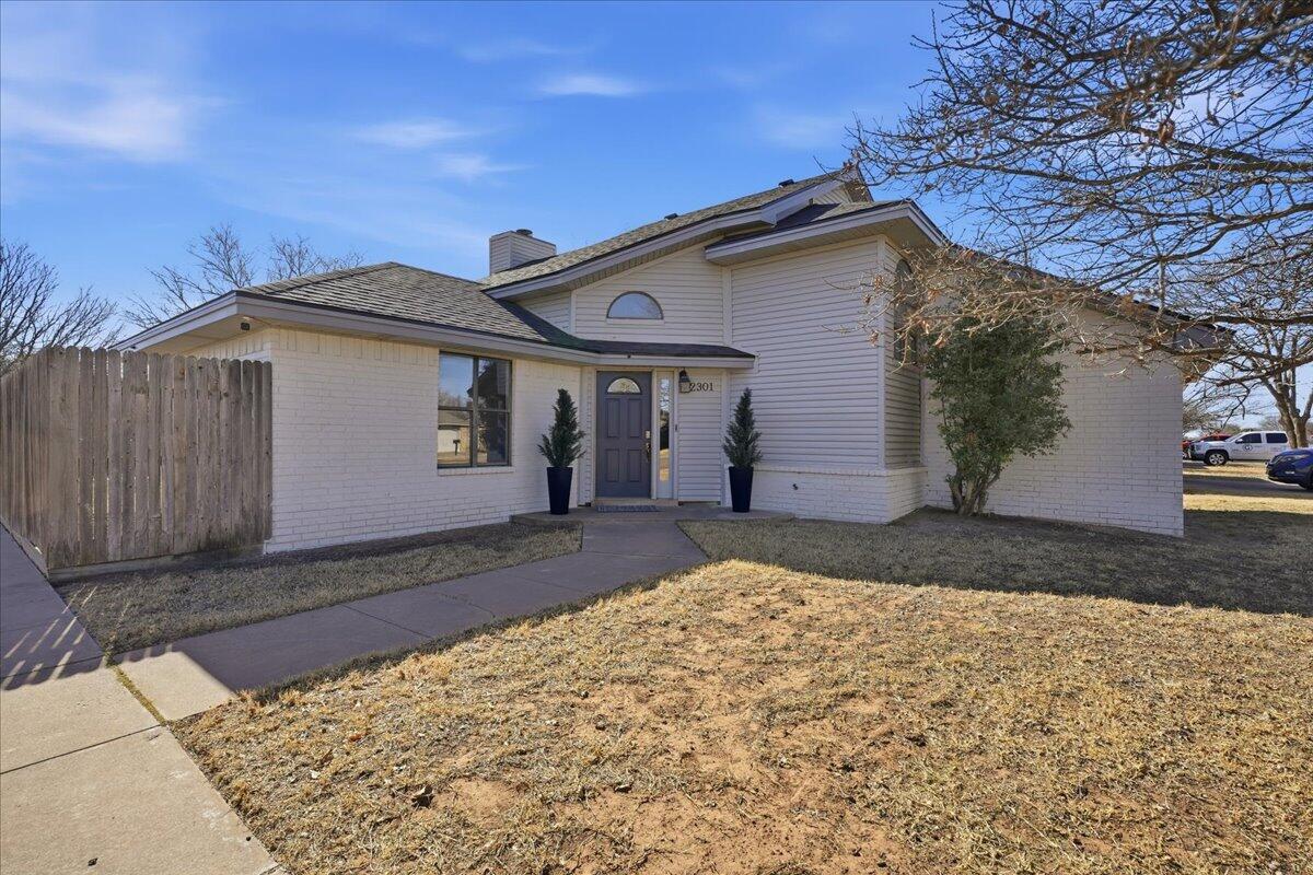 2301 92nd Street Lubbock, TX 79423 - Photo 2 of 30 a front view of a house with a yard