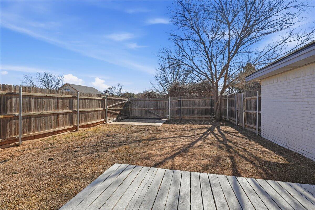 2301 92nd Street Lubbock, TX 79423 - Photo 27 of 30 a view of backyard with wooden fence