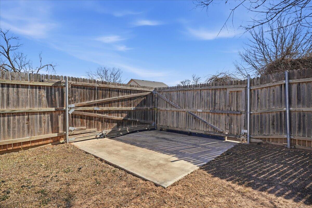 2301 92nd Street Lubbock, TX 79423 - Photo 28 of 30 a view of a house with wooden floor next to a yard