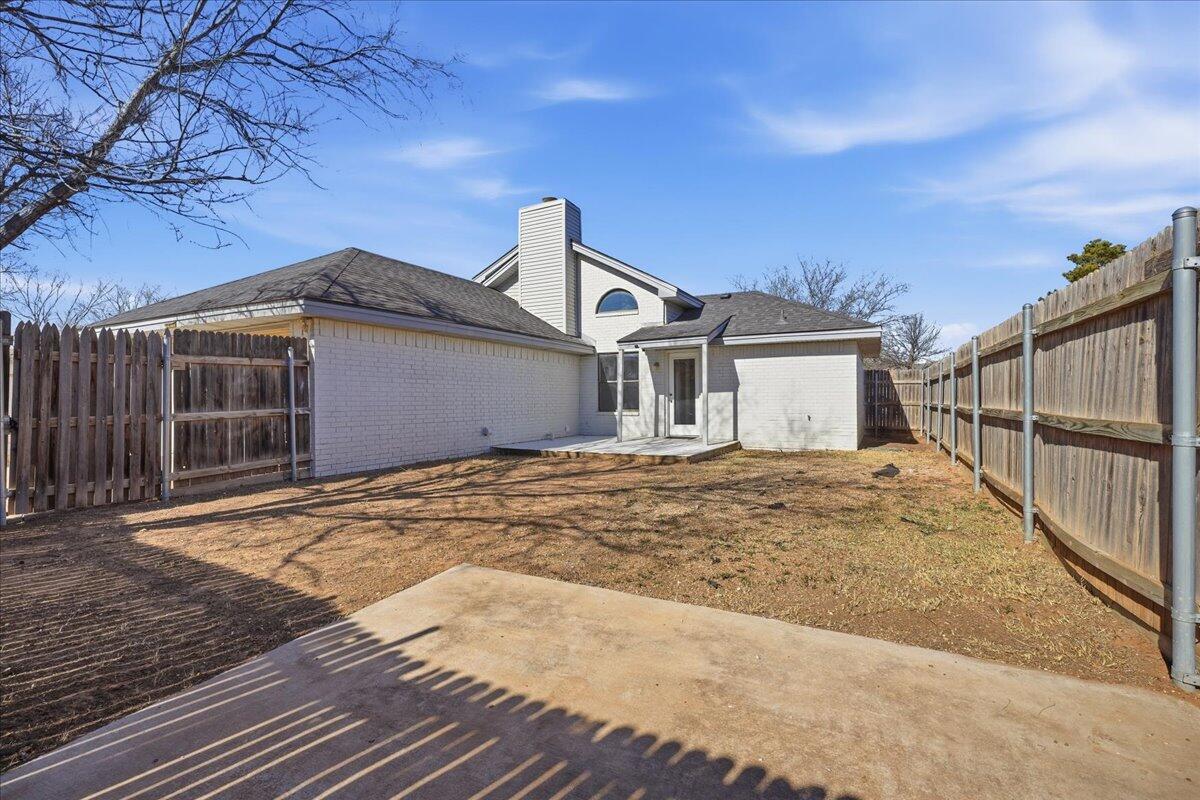 2301 92nd Street Lubbock, TX 79423 - Photo 29 of 30 a view of a house with a wooden fence