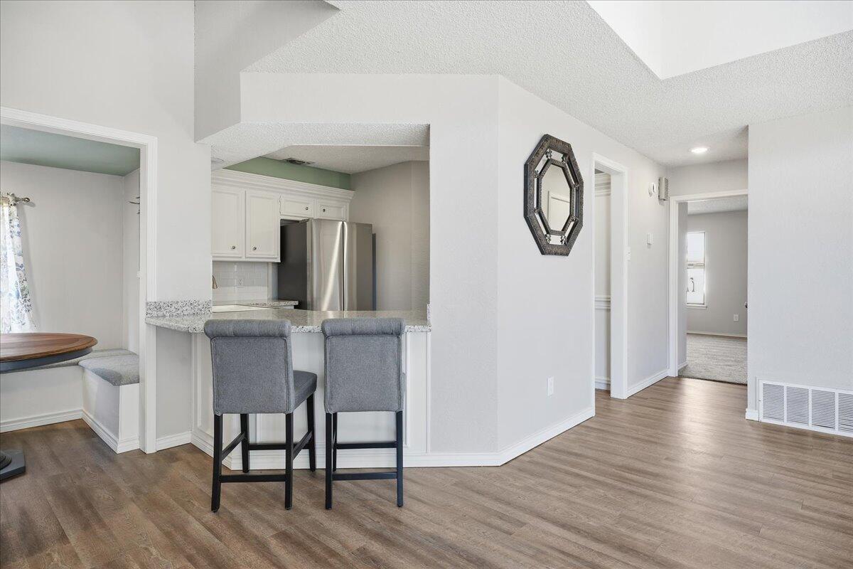 2301 92nd Street Lubbock, TX 79423 - Photo 8 of 30 a kitchen with stainless steel appliances granite countertop a table and chairs in it