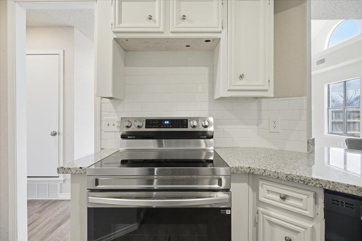 2301 92nd Street Lubbock, TX 79423 - Photo 10 of 30 a stove top oven sitting inside of a kitchen
