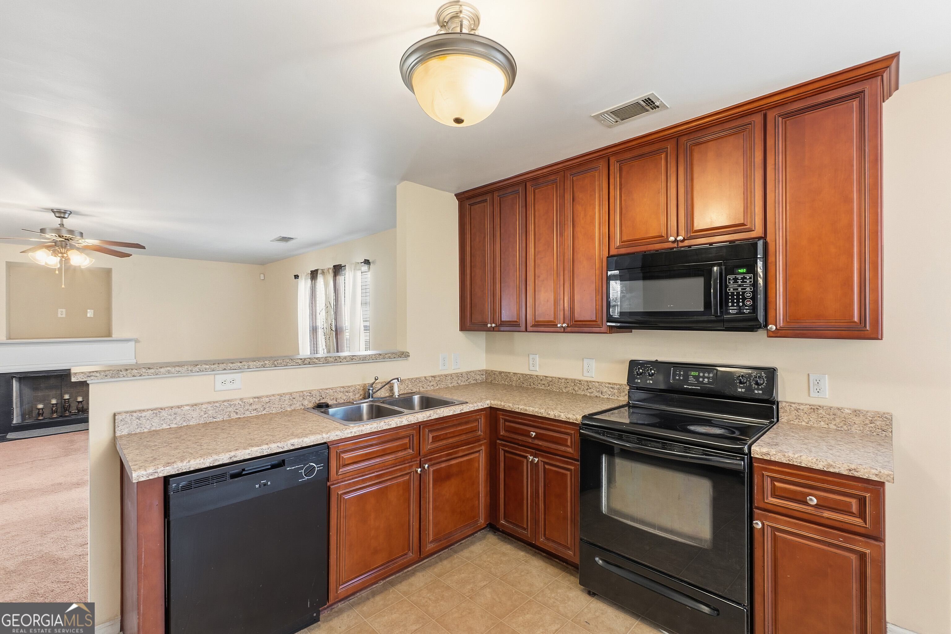 102 Steeple Court Perry, GA 31069 - Photo 10 of 37 a kitchen with stainless steel appliances granite countertop a stove microwave and sink