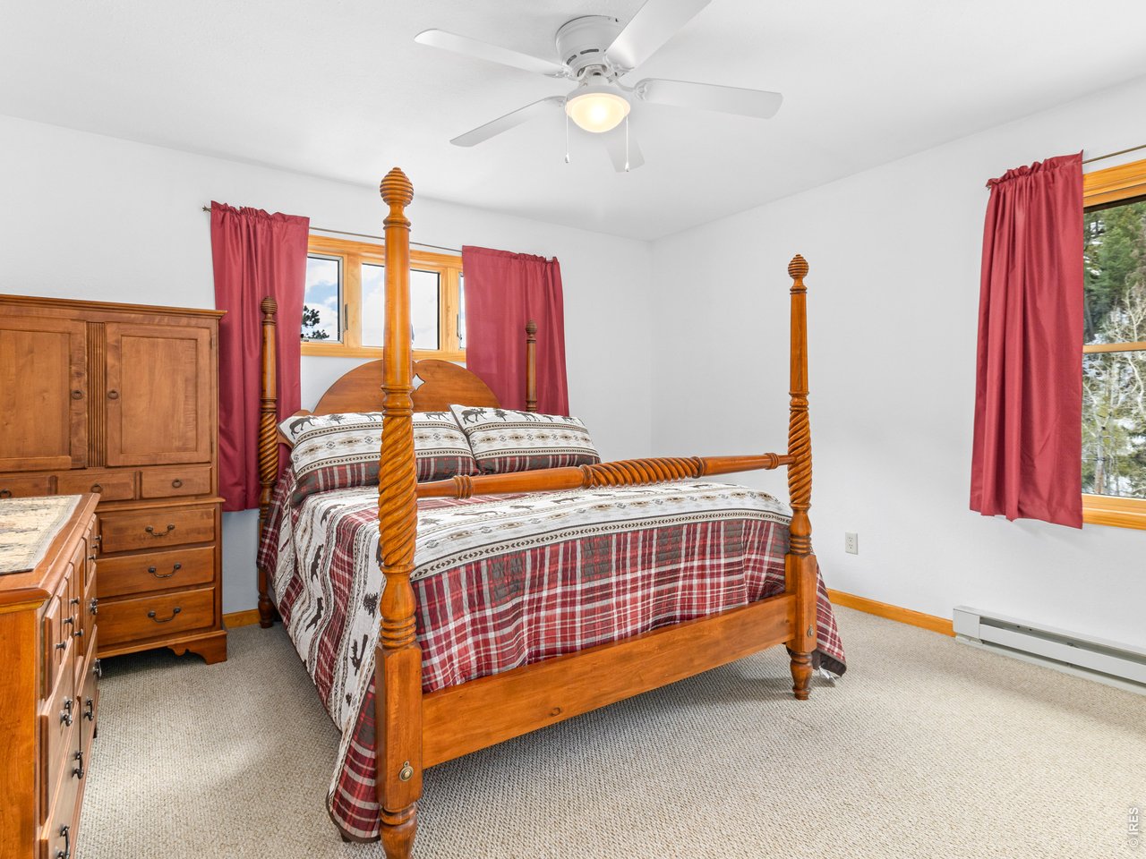 1002 Streamside Drive Drake, CO 80515 - Photo 12 of 37 a bedroom with a bed and a chandelier